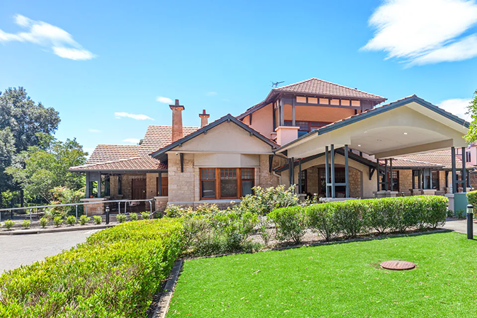 Heritage-style building with a lawn and landscaped garden