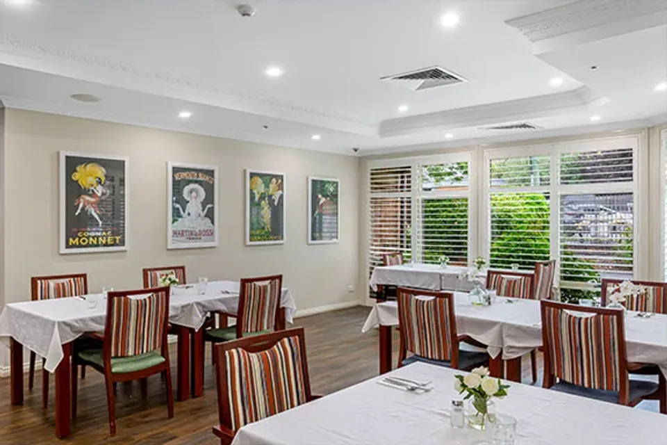 Dining room tables set with white linen
