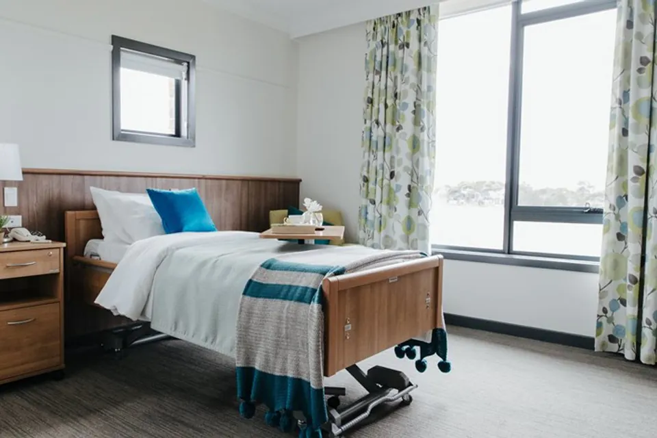 Resident bedroom with care bed and large windows