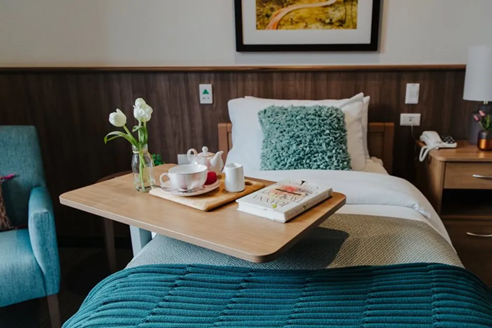 Bed with breakfast tray in a resident room