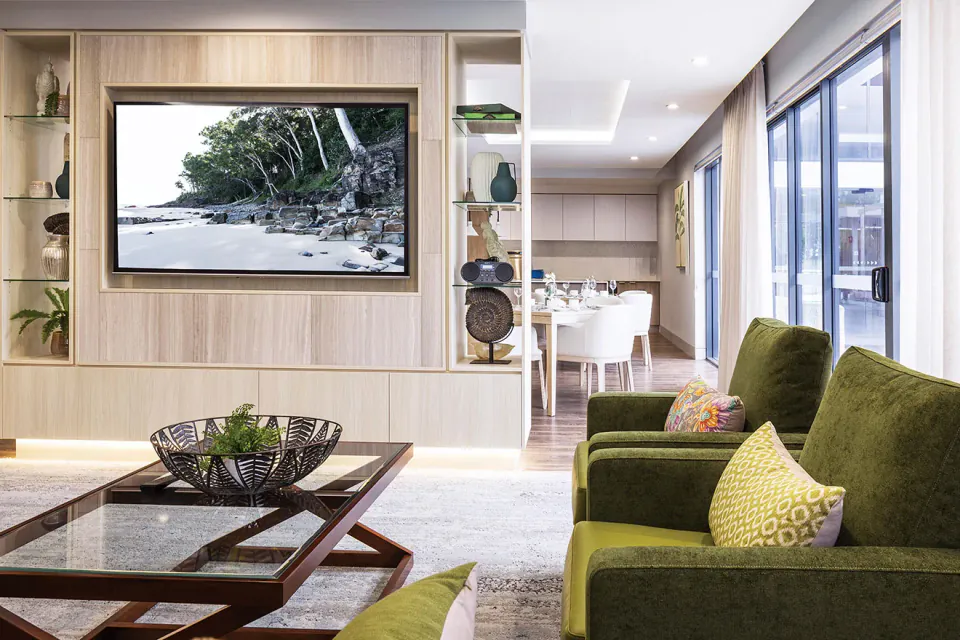 Lounge with green sofas and a view to a courtyard