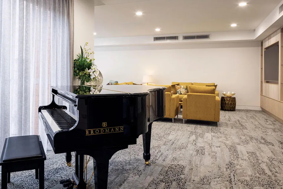 Grand piano beside armchairs in a lounge
