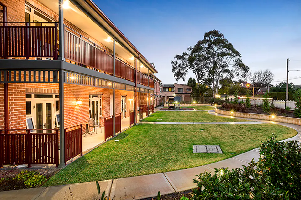 Landscaped courtyard between two-storey brick wings