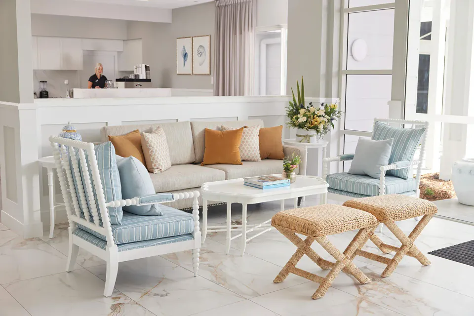 Sitting area with pale chairs beside a cafe counter