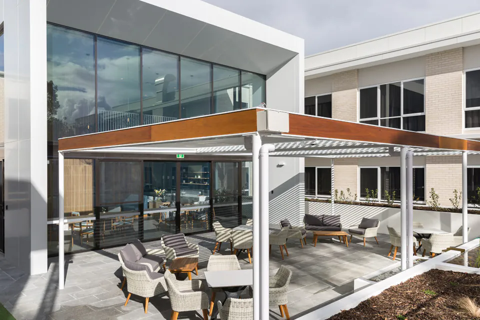 Modern residence exterior with covered courtyard seating