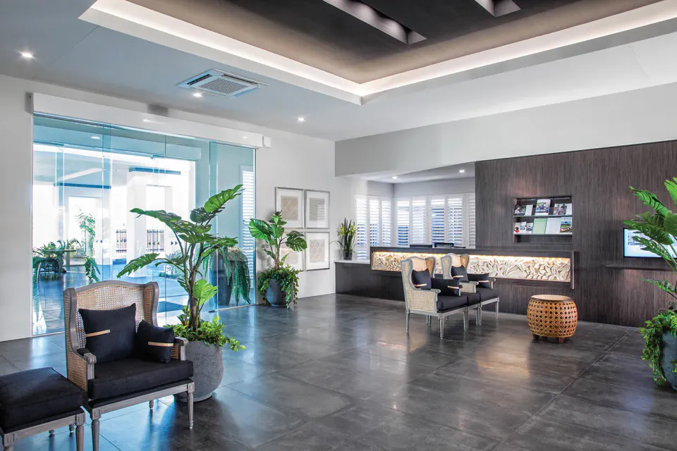 Reception lounge with armchairs and planted pots