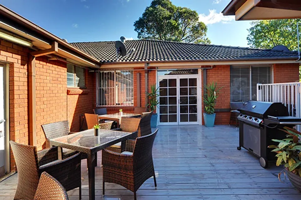Brick courtyard with an outdoor dining table