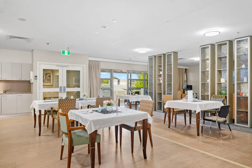Dining room with set tables and display cabinets
