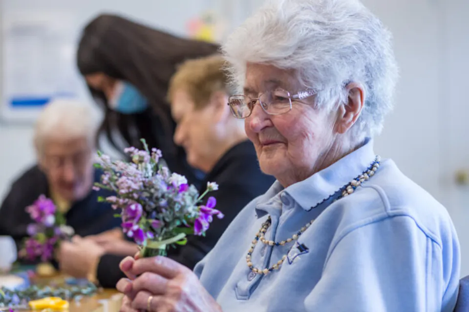 Resident arranging flowers during an activity