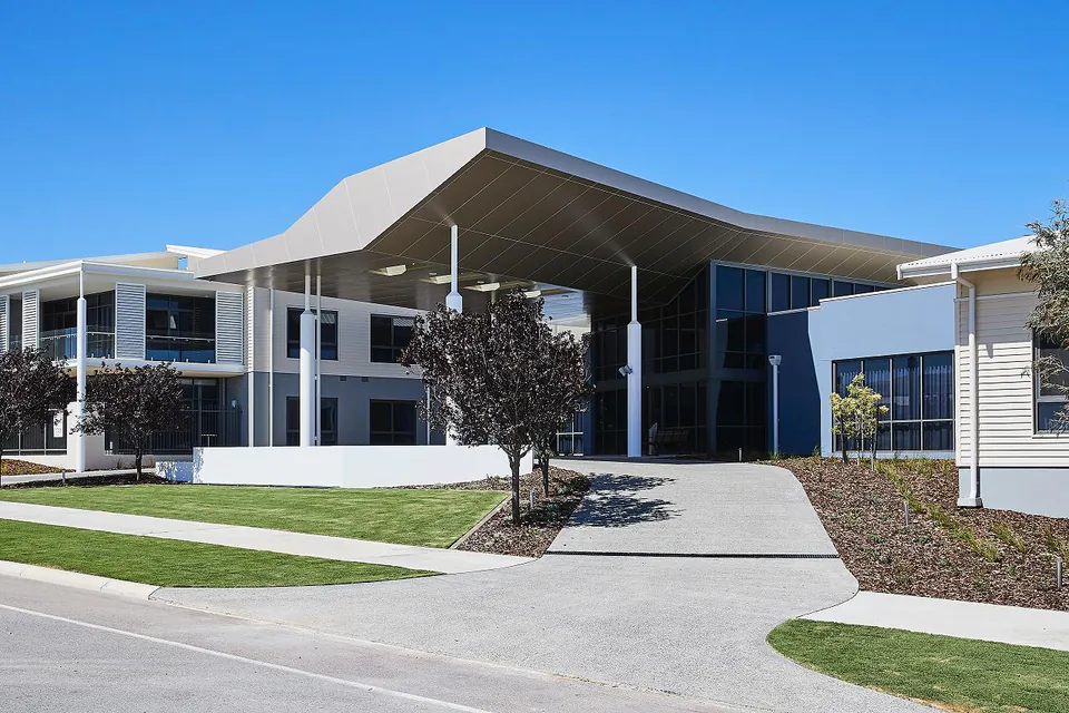 Modern two-storey residence with a covered entrance and broad path.