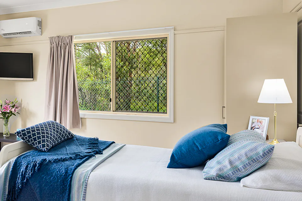 Bedroom with a single bed and a window overlooking greenery
