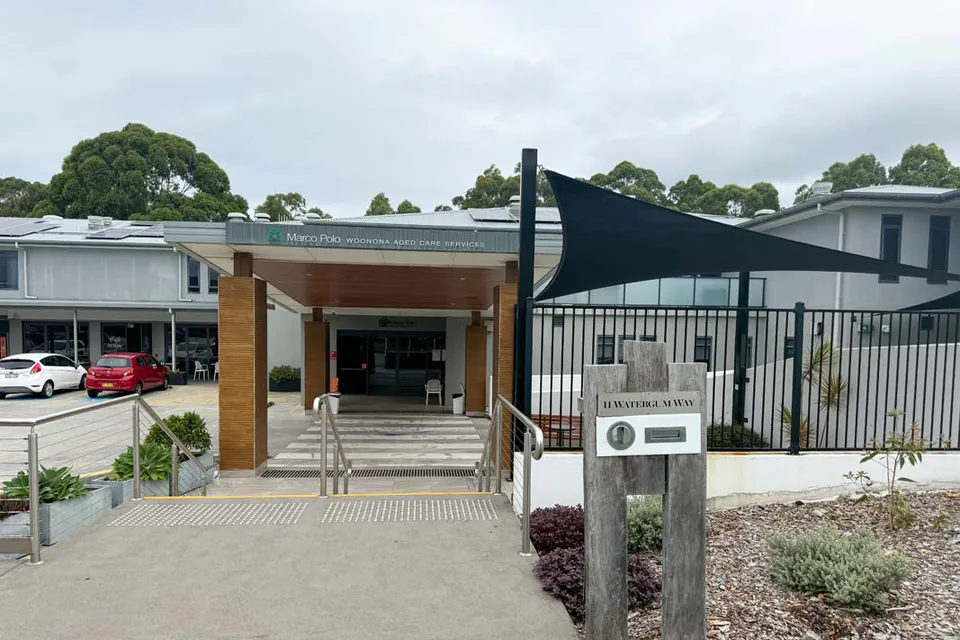 Entrance to the care building beside planted garden beds