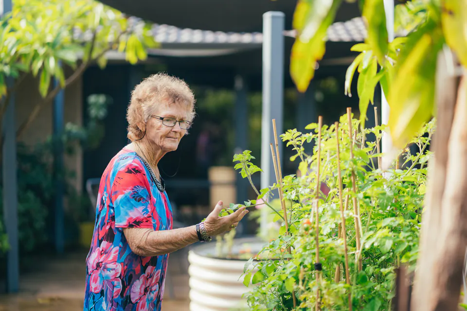 Resident tending plants in the garden