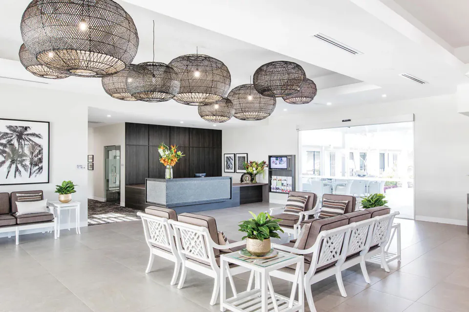 Entrance lounge with pendant lights and white chairs