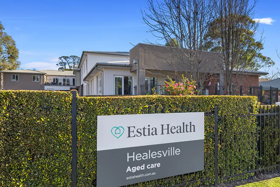 Building exterior behind a roadside sign