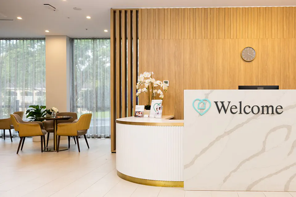 Curved welcome desk in a timber-lined lobby