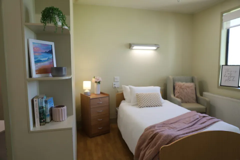 Bedroom with a single bed and window chair