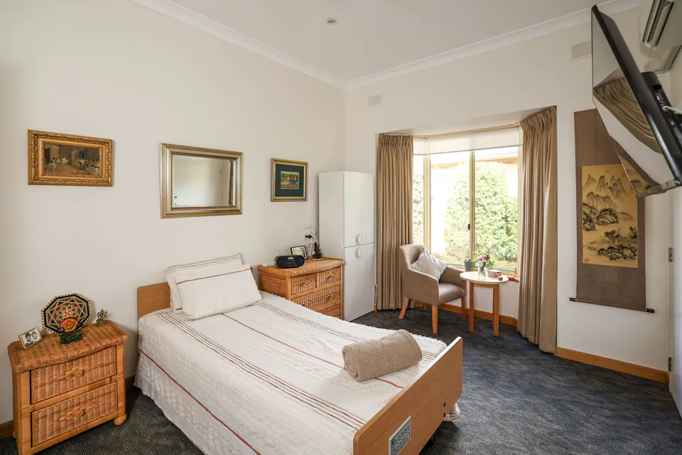 Bedroom with a single bed and garden-facing window
