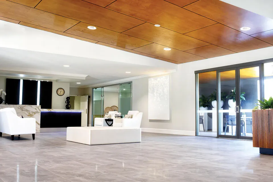Entrance lounge with timber ceiling and white seating