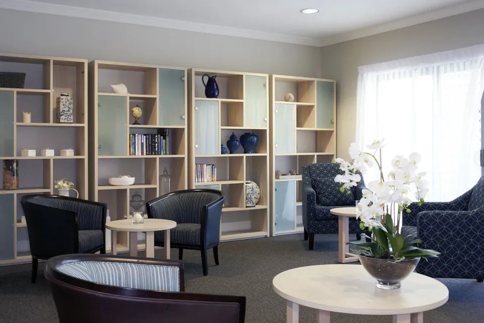 Sitting room with chairs beside wall shelves