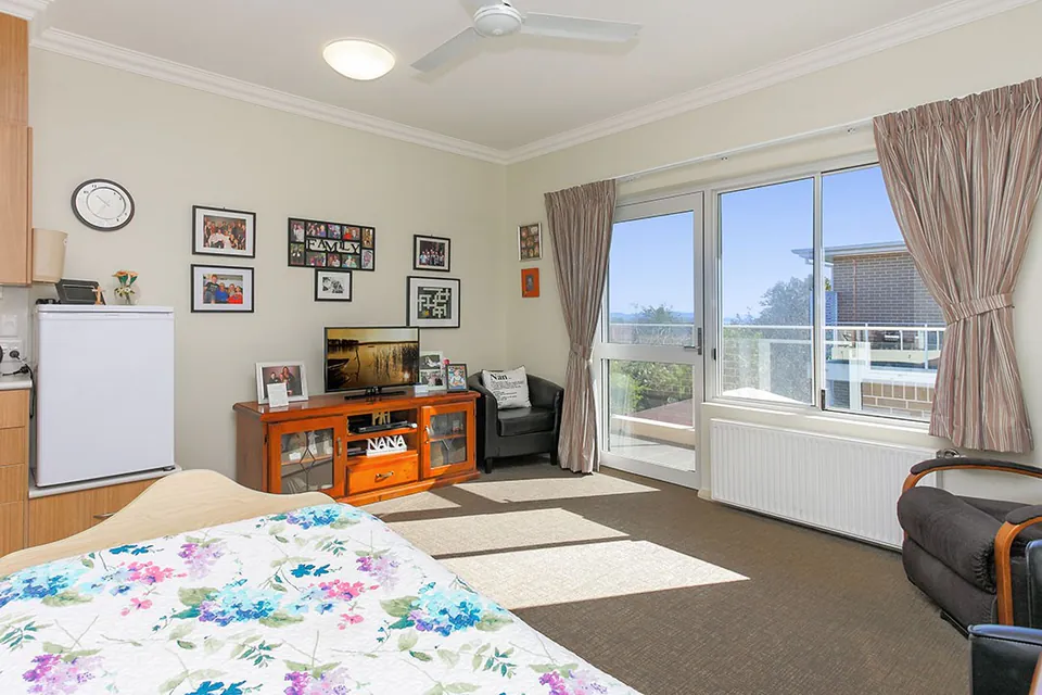 Resident bedroom with kitchenette and large window