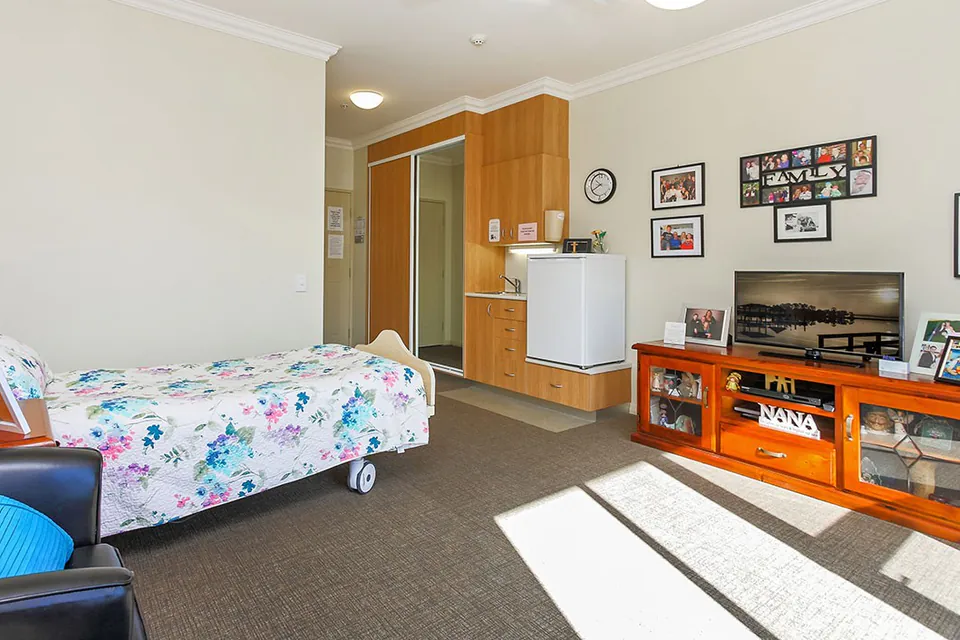 Resident bedroom with kitchenette and sitting area