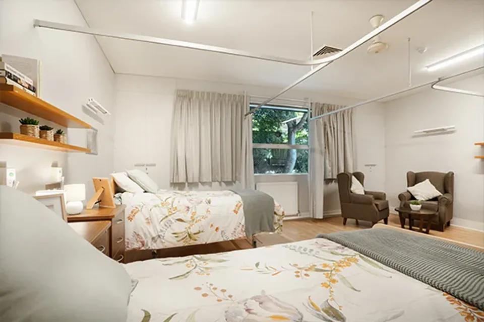 Shared bedroom with two beds and recliners