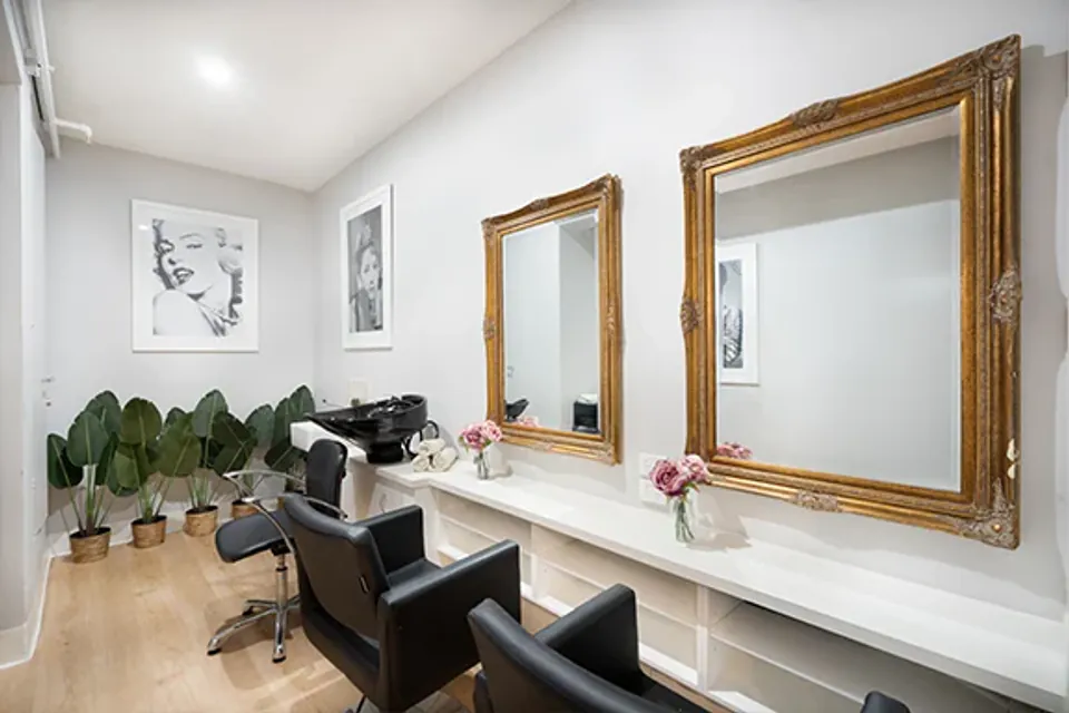 Hair salon with styling chair and mirror