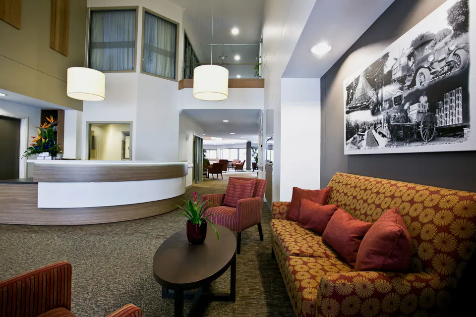 Reception area with patterned sofa and framed mural