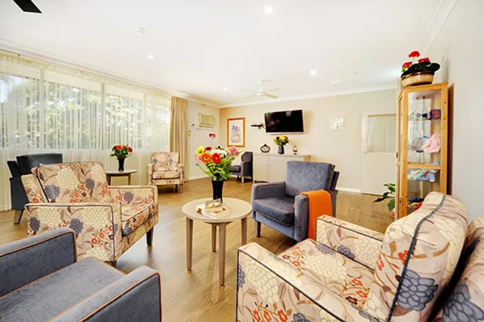 Lounge with floral armchairs and television