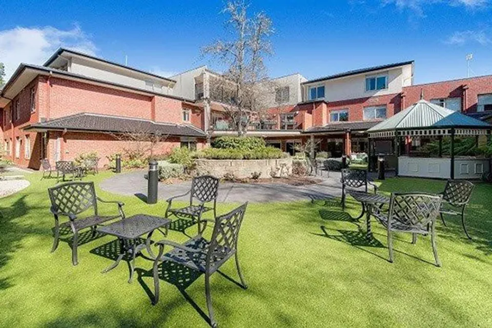 Garden lawn with outdoor tables and gazebo