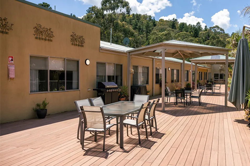 Timber-deck courtyard with outdoor dining tables