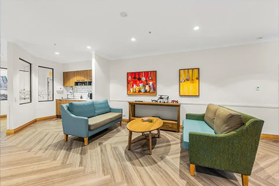 Lounge corner with sofas and colourful artwork